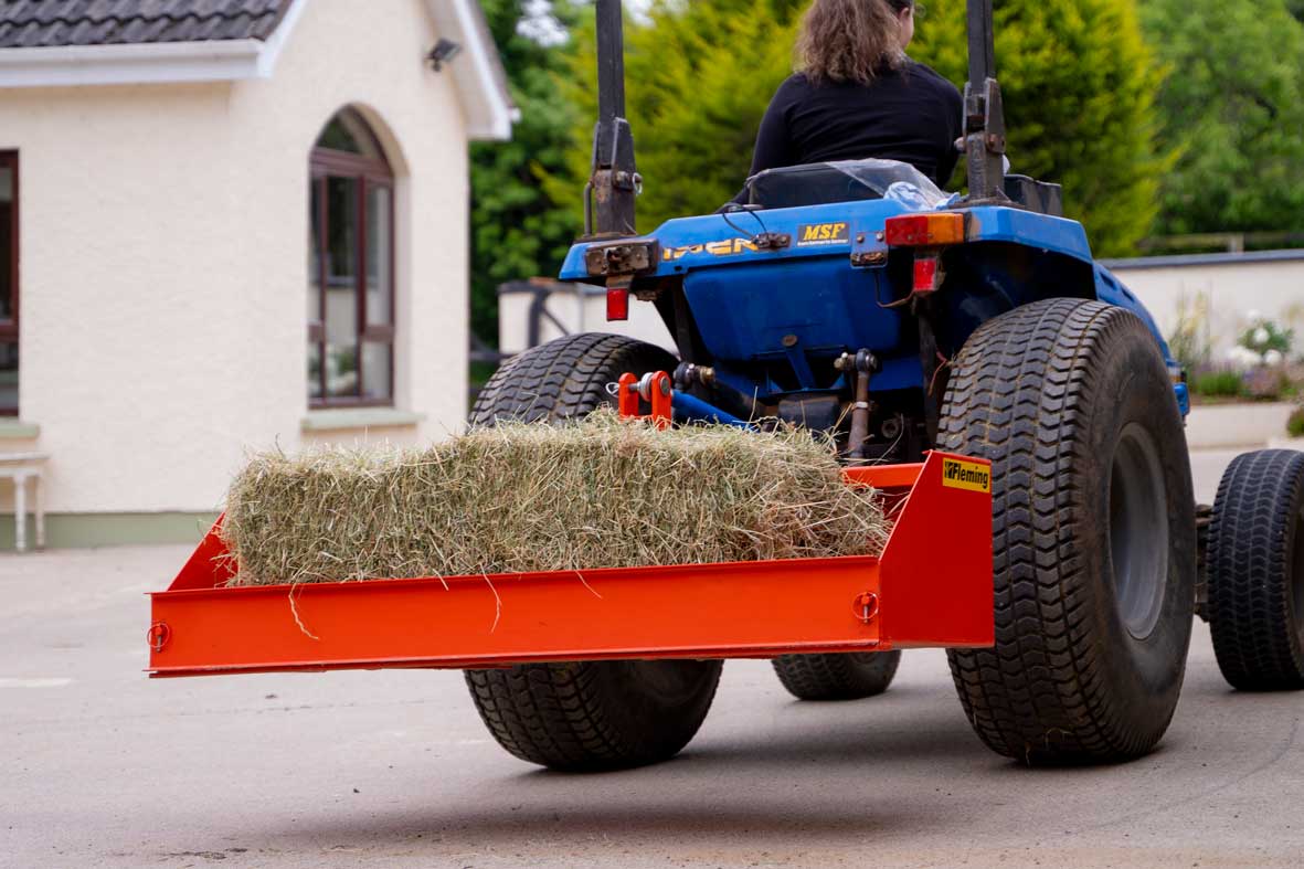 Blue tractor with a Fleming tractor transport box