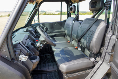 Interior of a CFMOTO U10 Pro with steering wheel and seats, showing a clear view of the dashboard and windows.