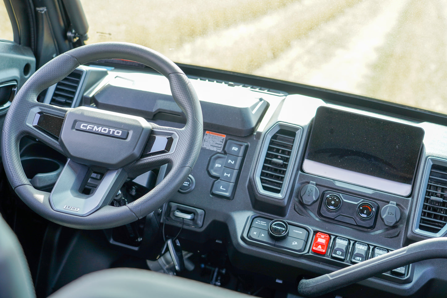 Steering wheel and dashboard of a vehicle with 'CFMOTO' branding.