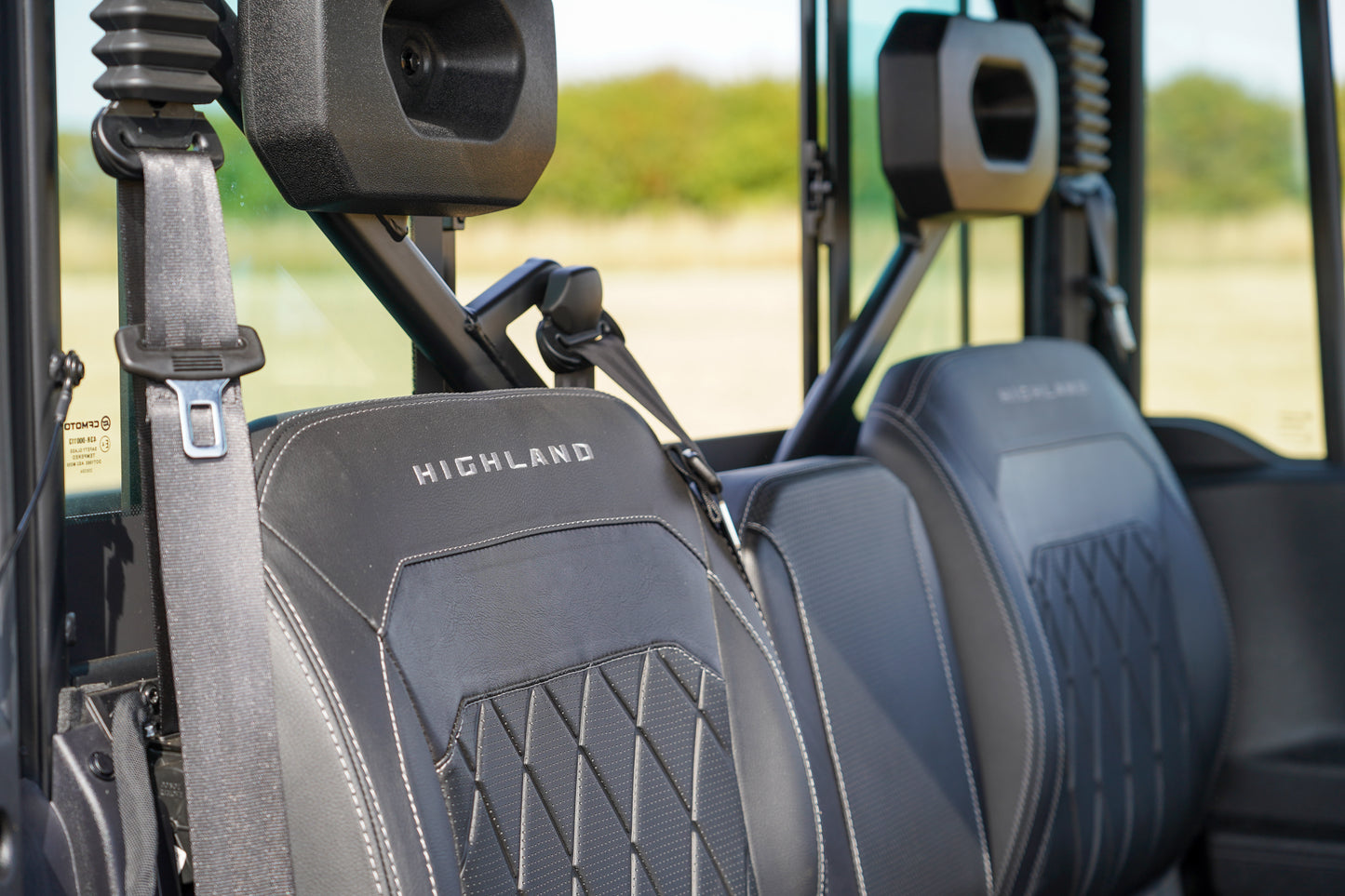 Close-up of CFMOTO U10 Pro Highland vehicle seats with visible branding.