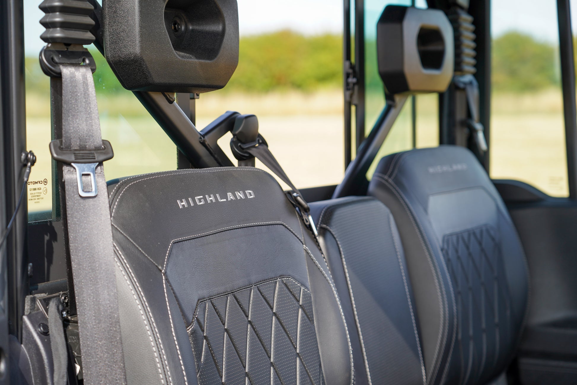 Close-up of CFMOTO U10 Pro Highland vehicle seats with visible branding.