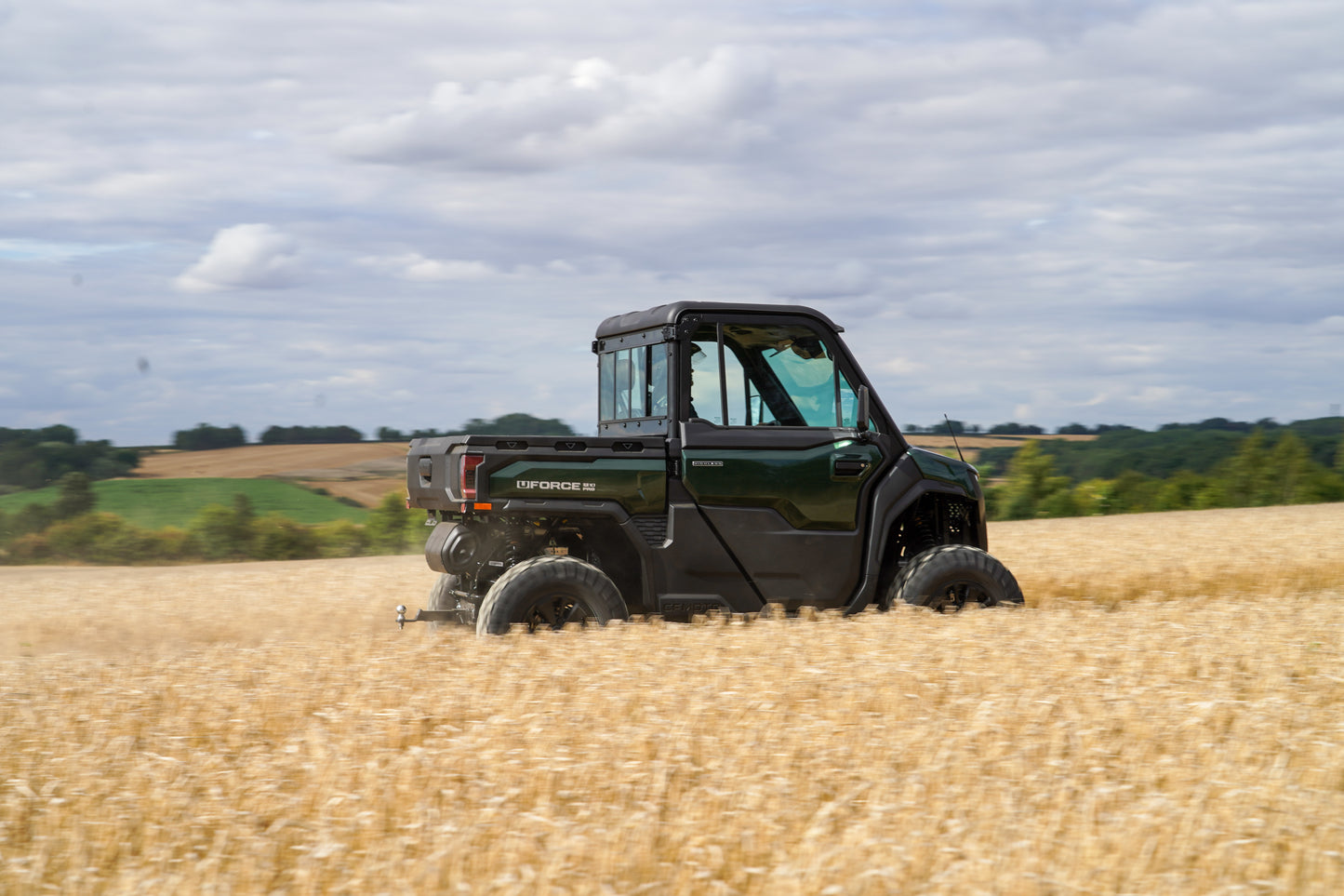 CFMOTO UTV in a field with a cloudy sky