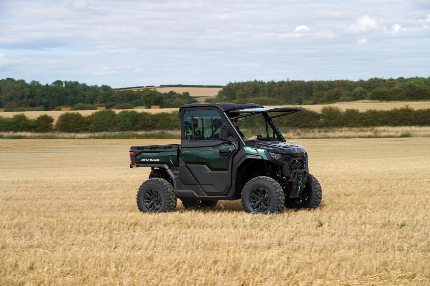 CFMOTO U10 Pro UTV vehicle in a field with trees and sky in the background