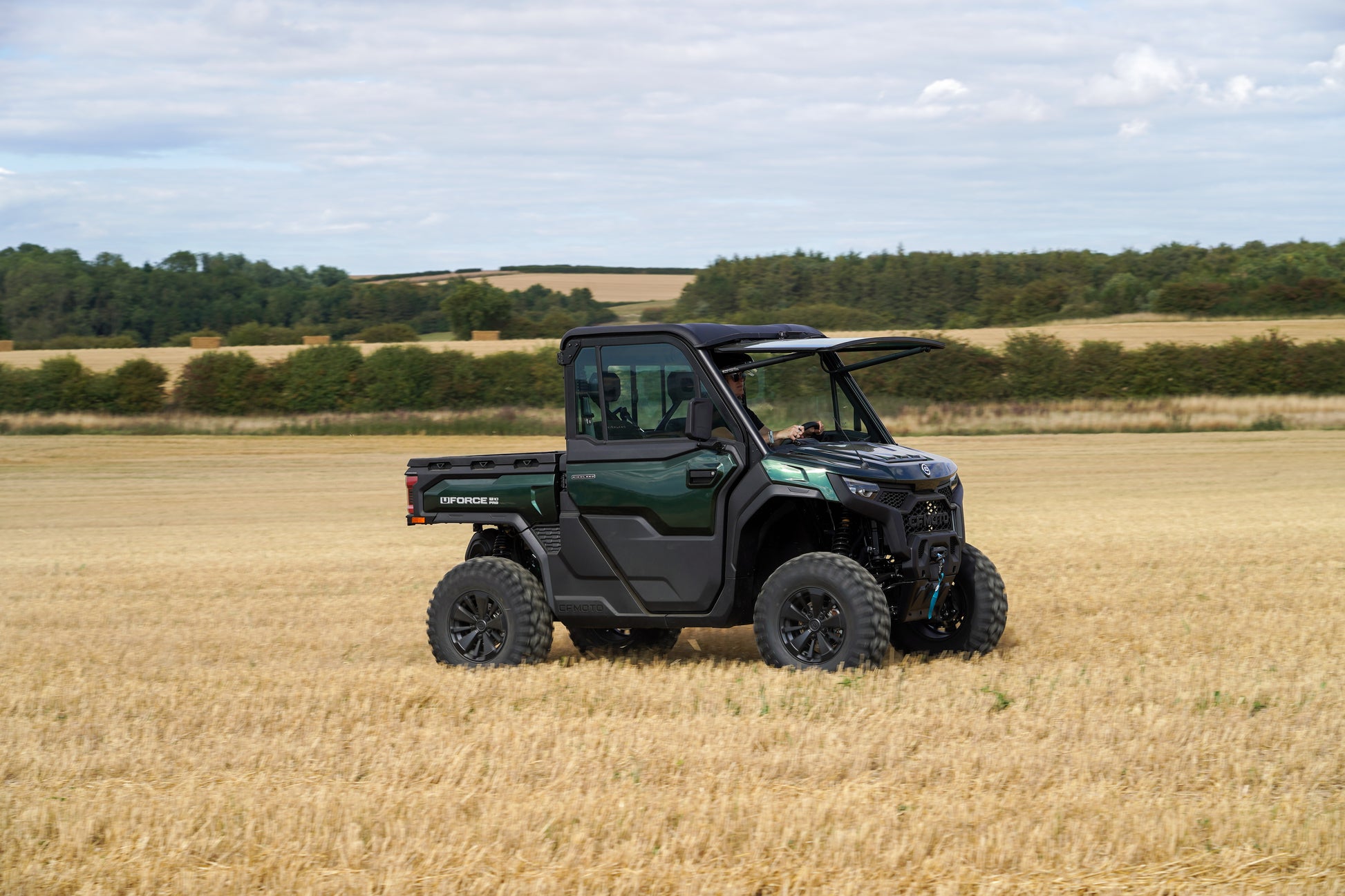 CFMOTO U10 Pro UTV vehicle in a field with trees and sky in the background