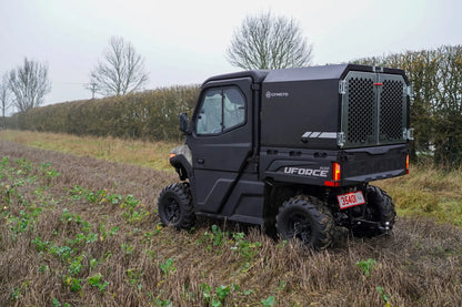 CFMOTO UFORCE 600 Highland UTV parked in a field with trees in the background