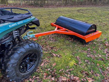 Can-Am ATV with a FarmMaster land roller attached on a grassy field