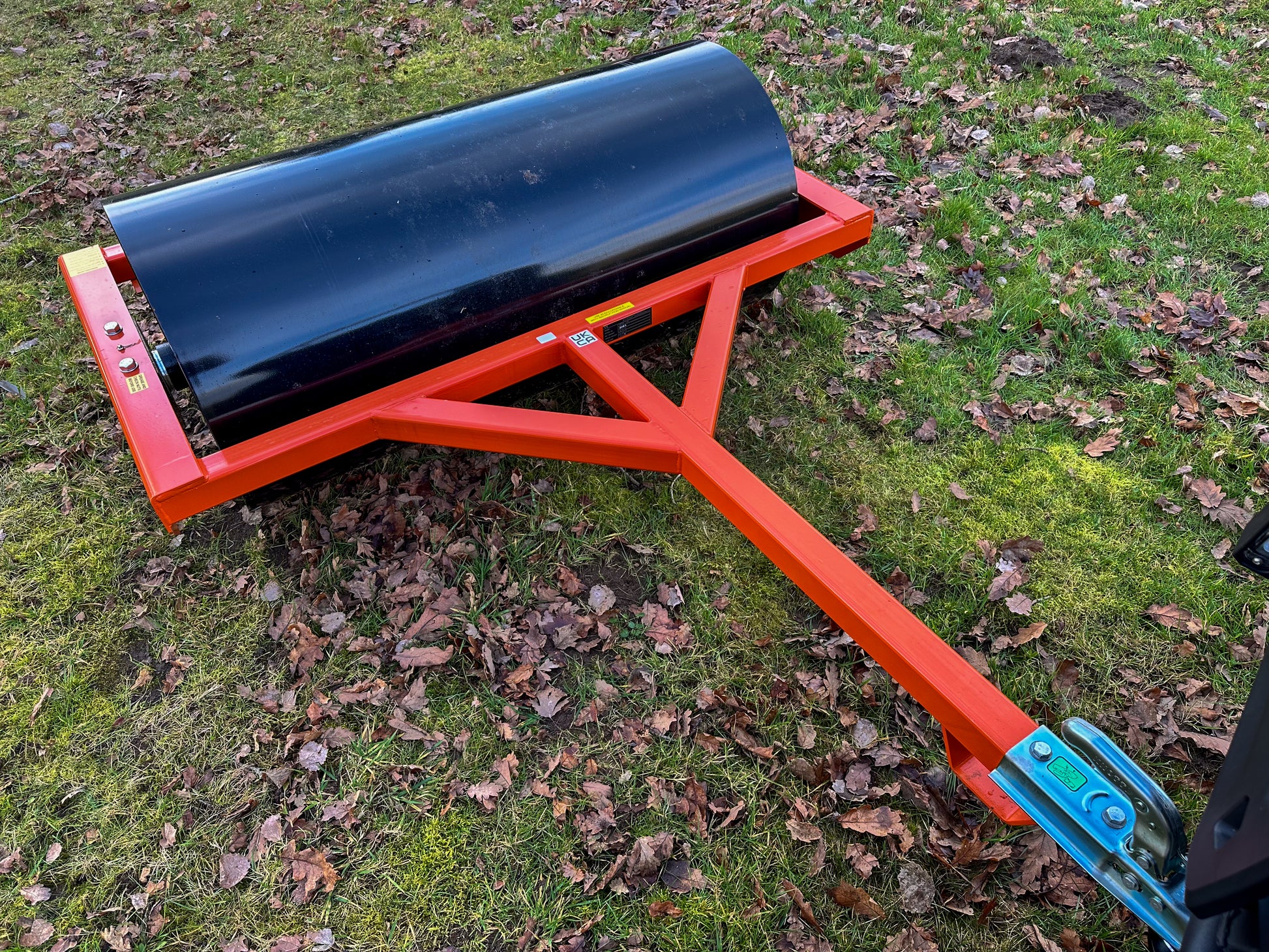 FarmMaster land roller on grass with scattered leaves
