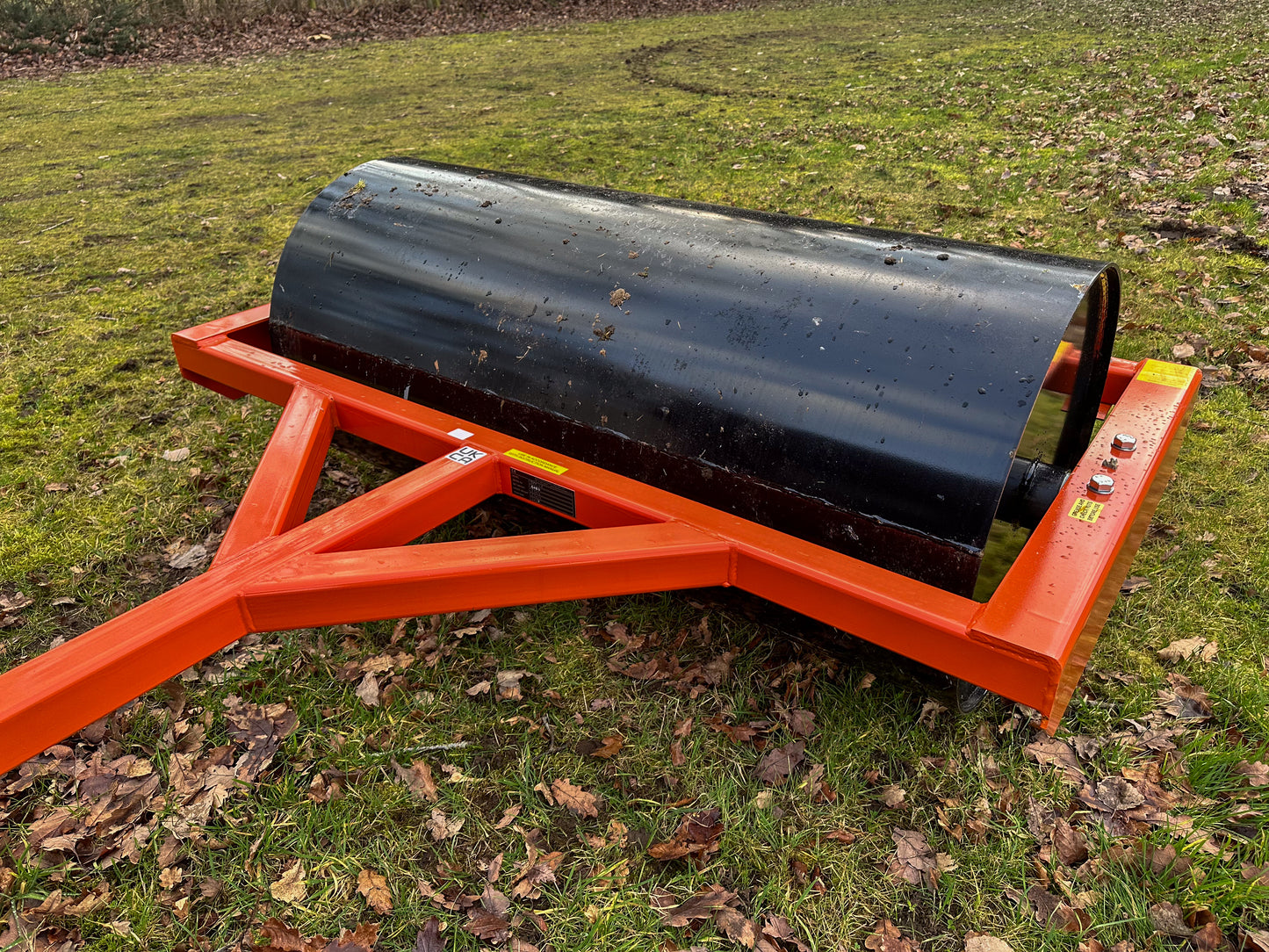FarmMaster ATV land roller on a grassy field with leaves