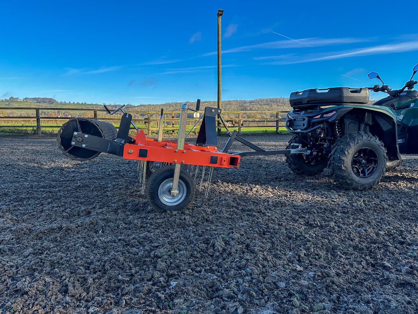FarmMaster ATV arena conditioner with an ATV in the background.
