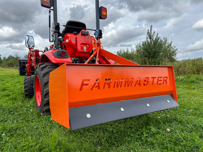 FarmMaster tractor box grader  attachment on a grassy field.