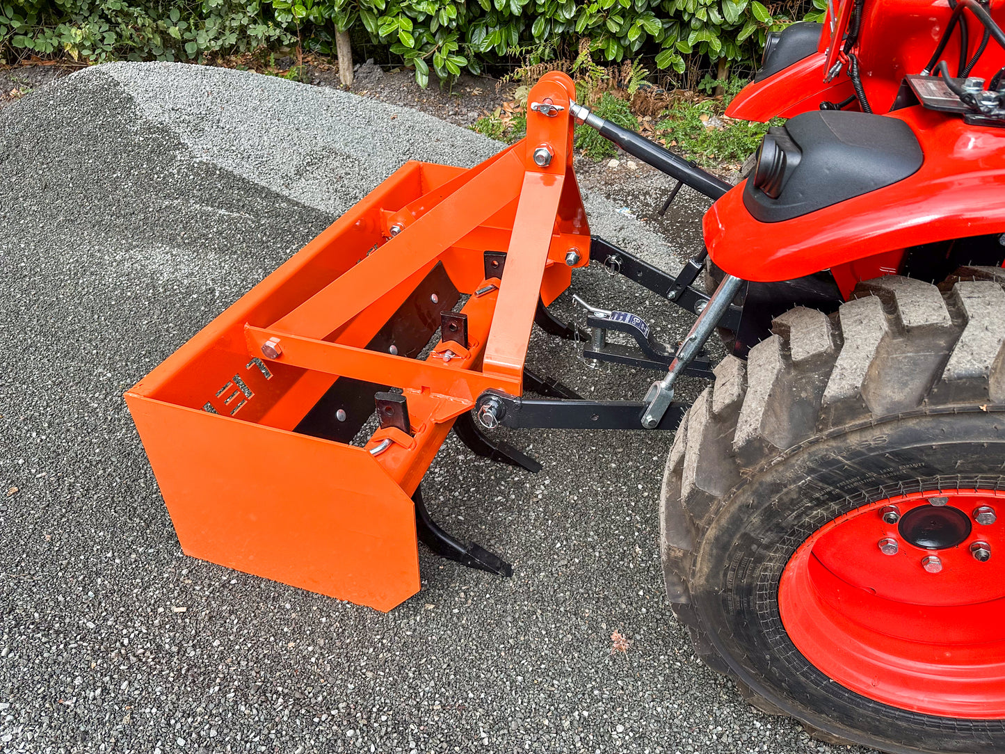 FarmMaster tractor box grader attachment on a gravel surface.