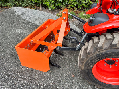 FarmMaster tractor box grader attachment on a gravel surface.