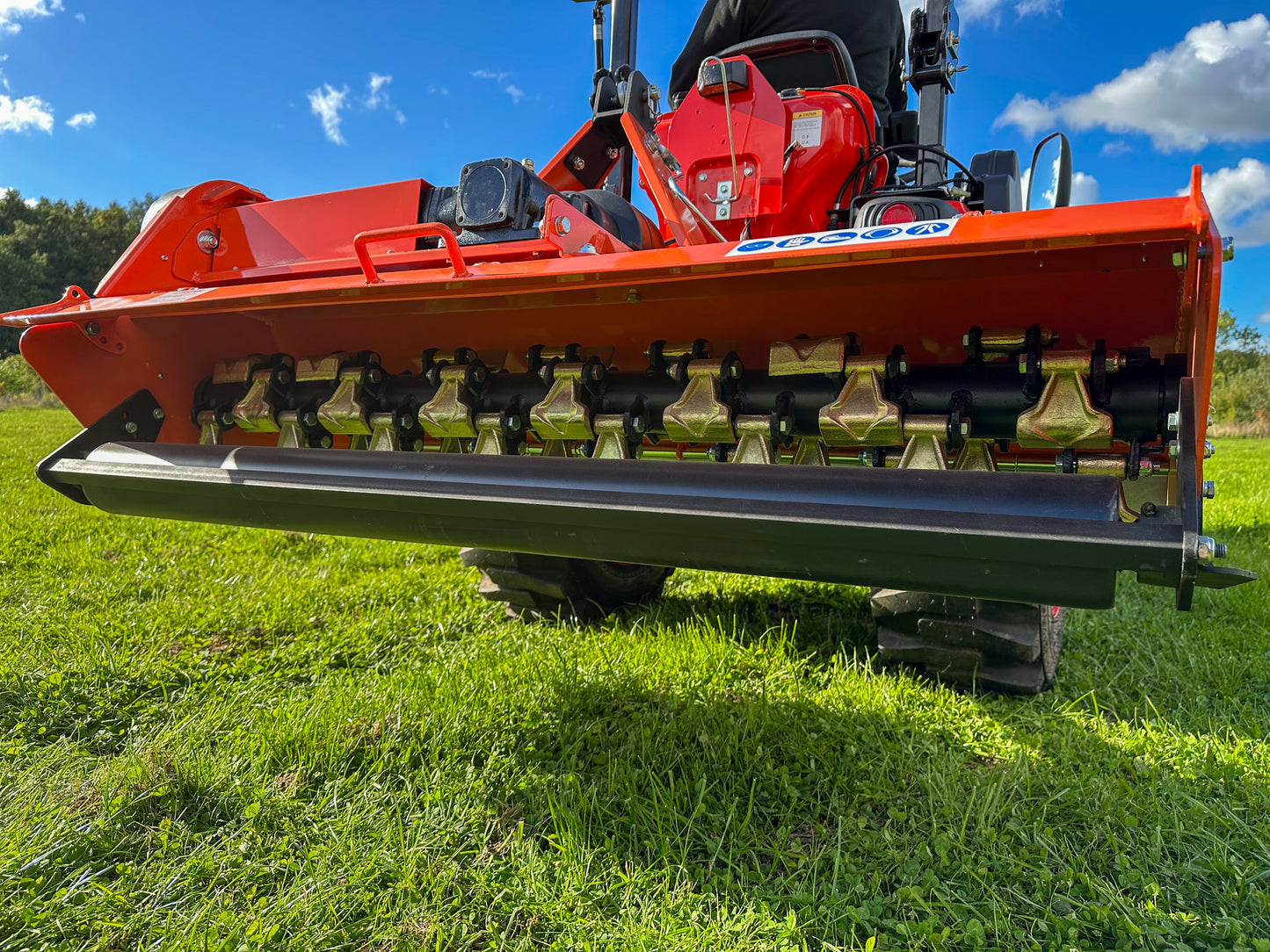 FarmMaster Flail Mower on a grassy field with a blue sky.