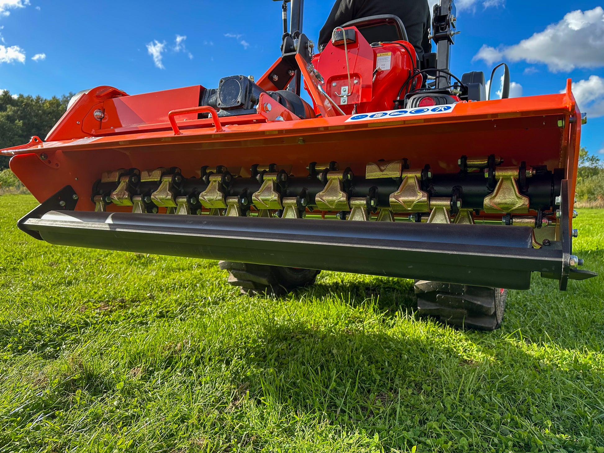 FarmMaster Flail Mower on a grassy field with a blue sky.