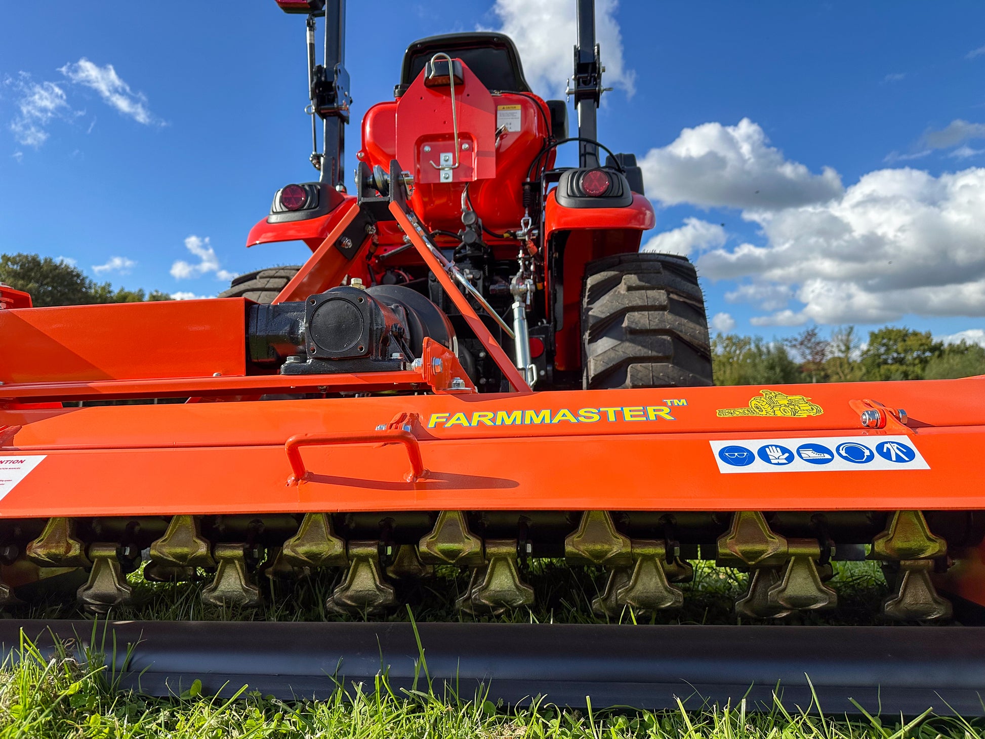 FarmMaster flail mower against a blue sky.