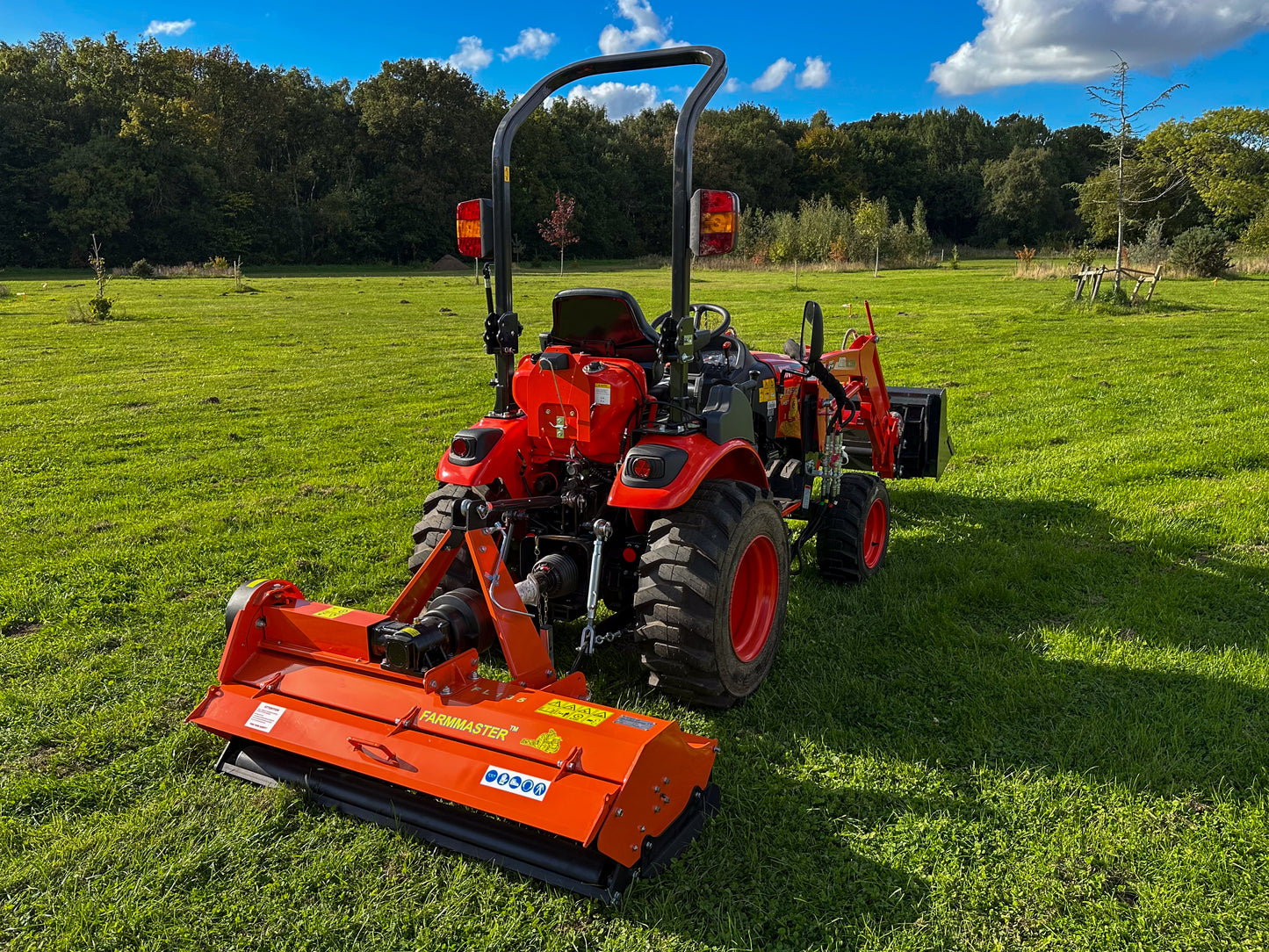 Kioti tractor with a FarmMaster flail mower attachment on a grassy field