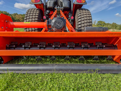 Close-up of a FarmMaster tractor flail mower on grass