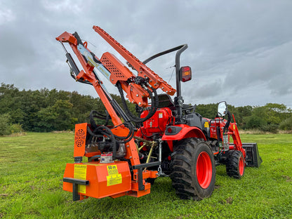 Kioti tractor with a large hedge cutter attachment in a grassy field