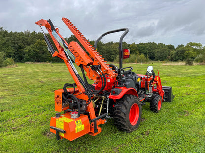Kioti tractor with FarmMaster hedge cutter in a grassy field