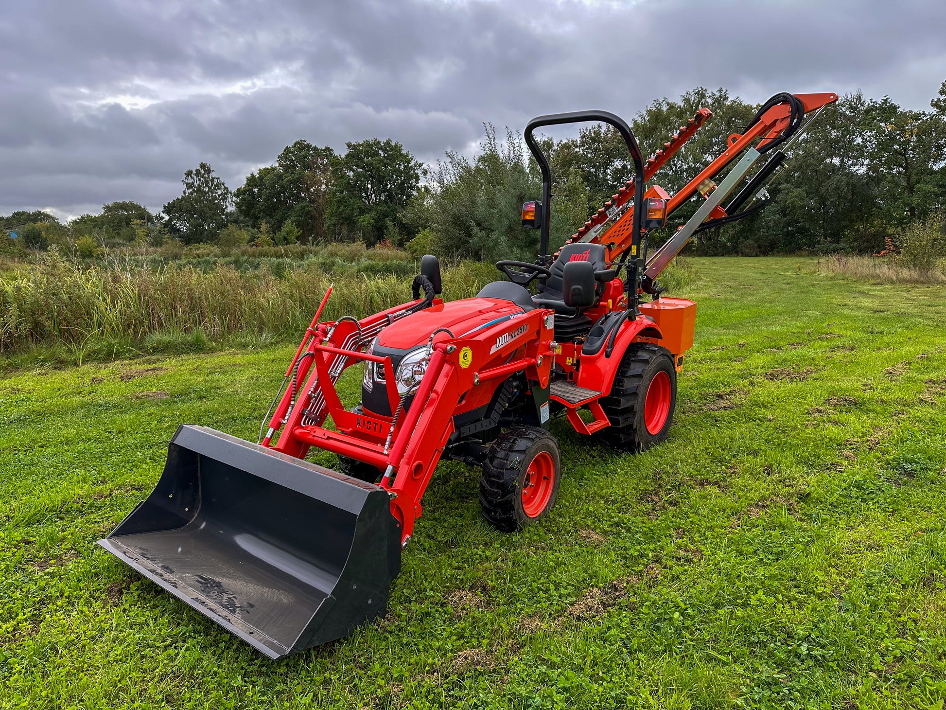 FarmMaster tractor hedge cutter on a grassy field