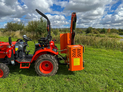 FarmMaster tractor hedge cutter in a grassy field under a cloudy sky.