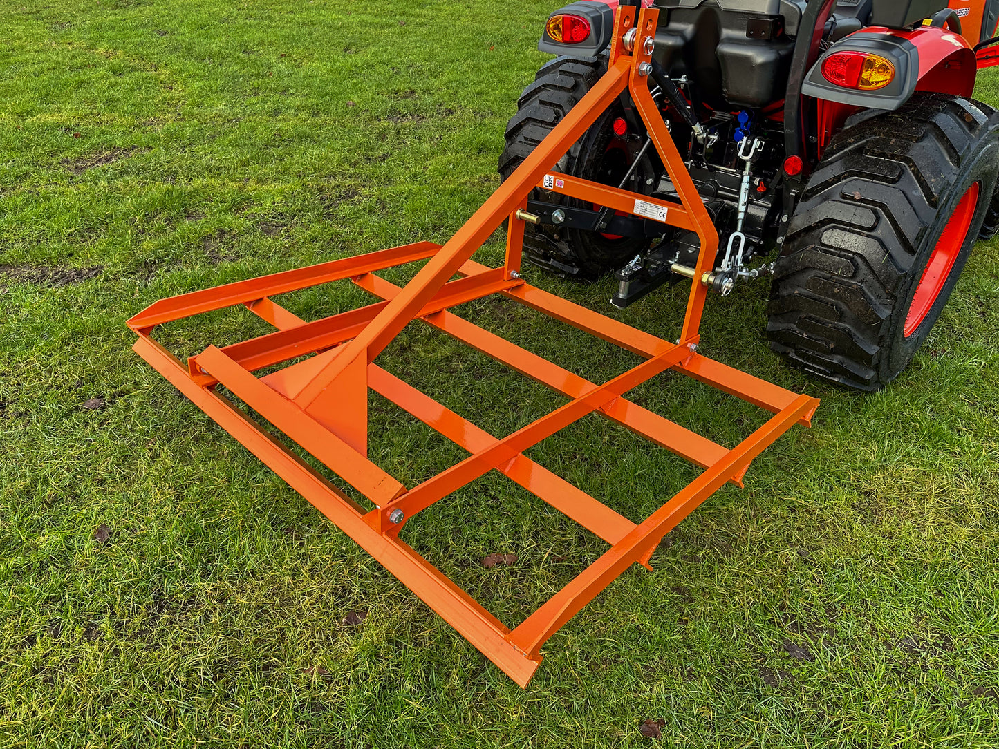 FarmMaster tractor leveller attached to a tractor on grass