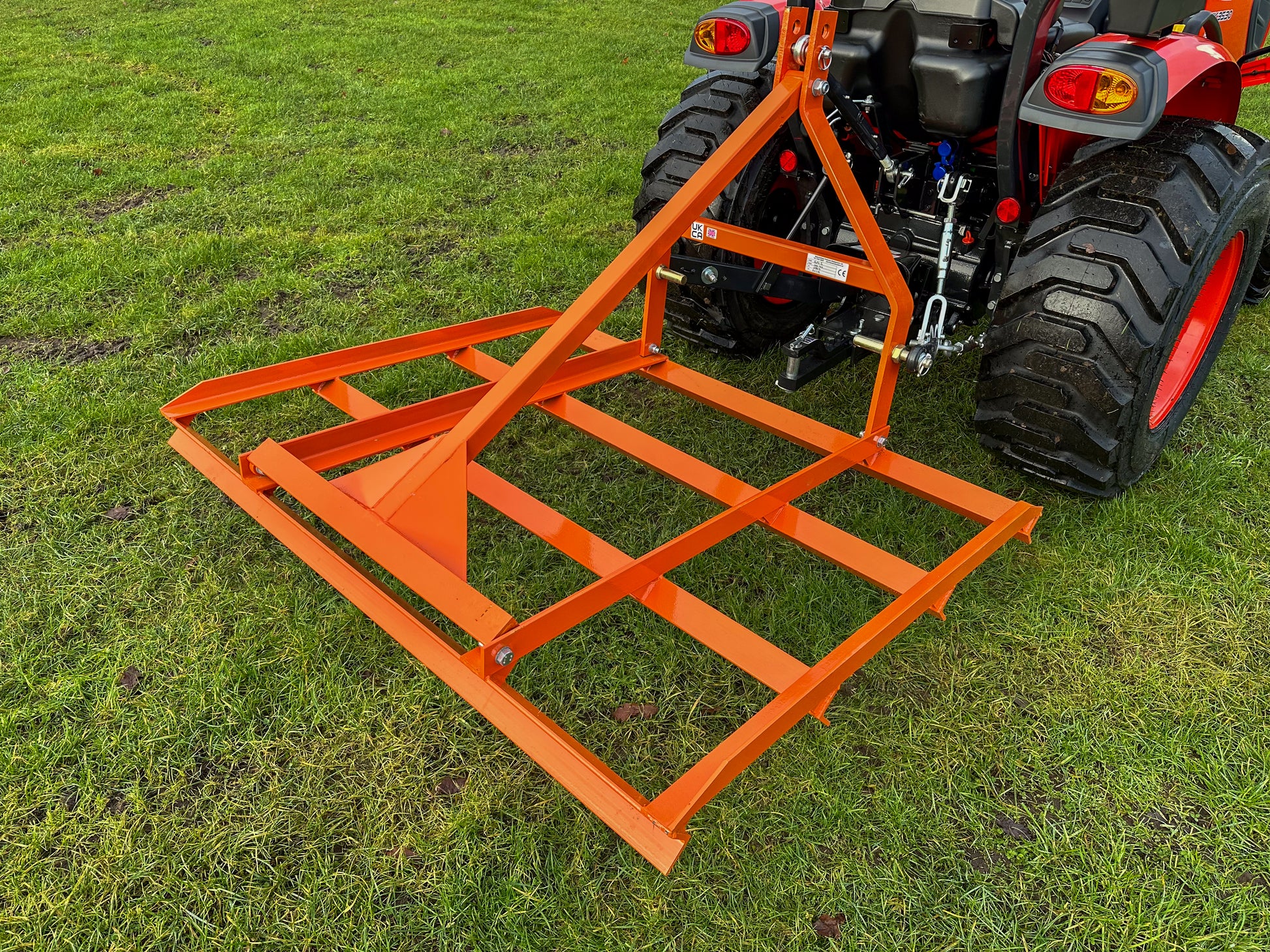 FarmMaster tractor leveller attached to a tractor on grass