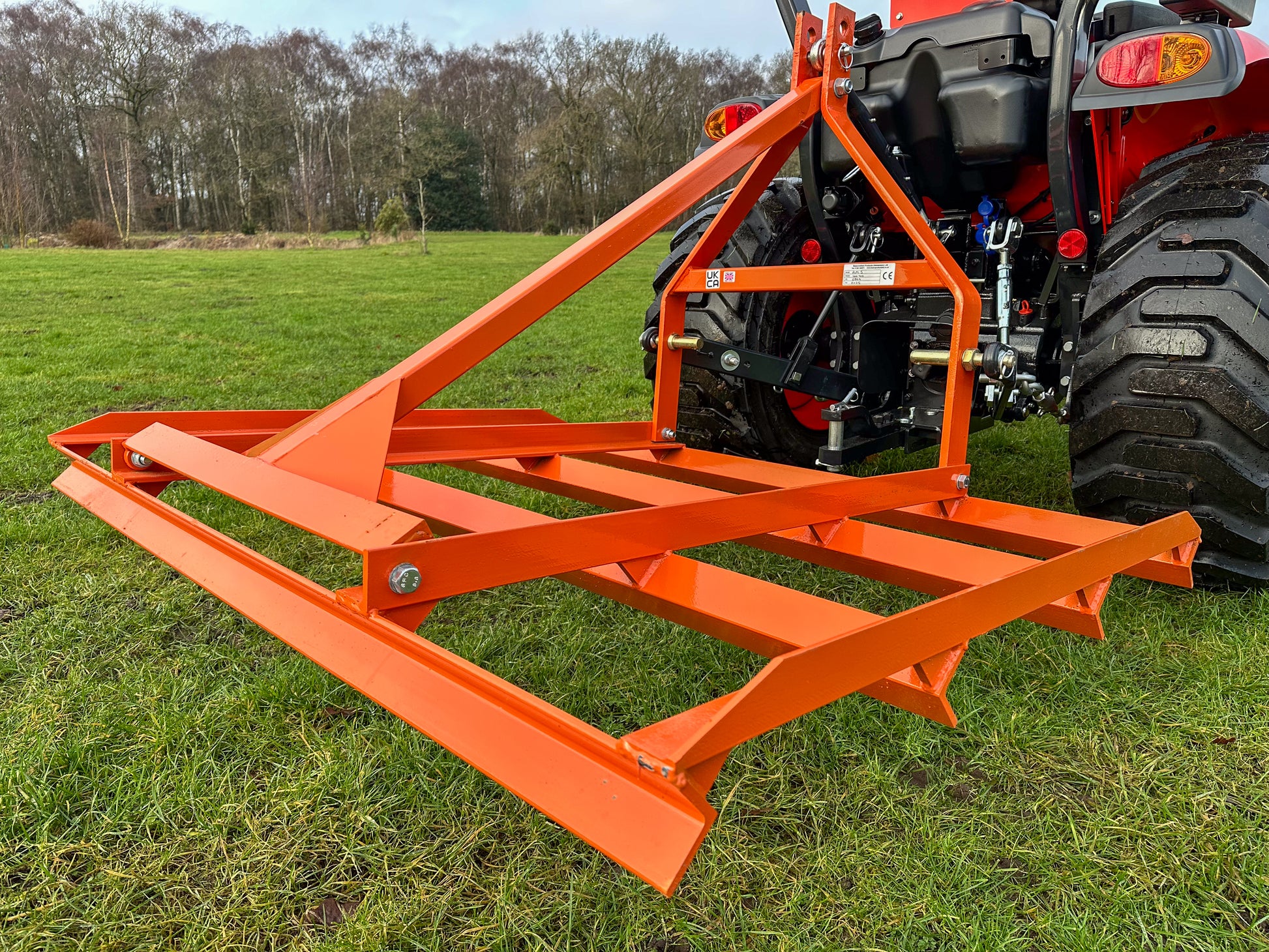 FarmMaster tractor leveller attached to a Kioti tractor in a field