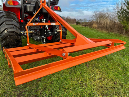 FarmMaster tractor leveller attached to a tractor on grassy field