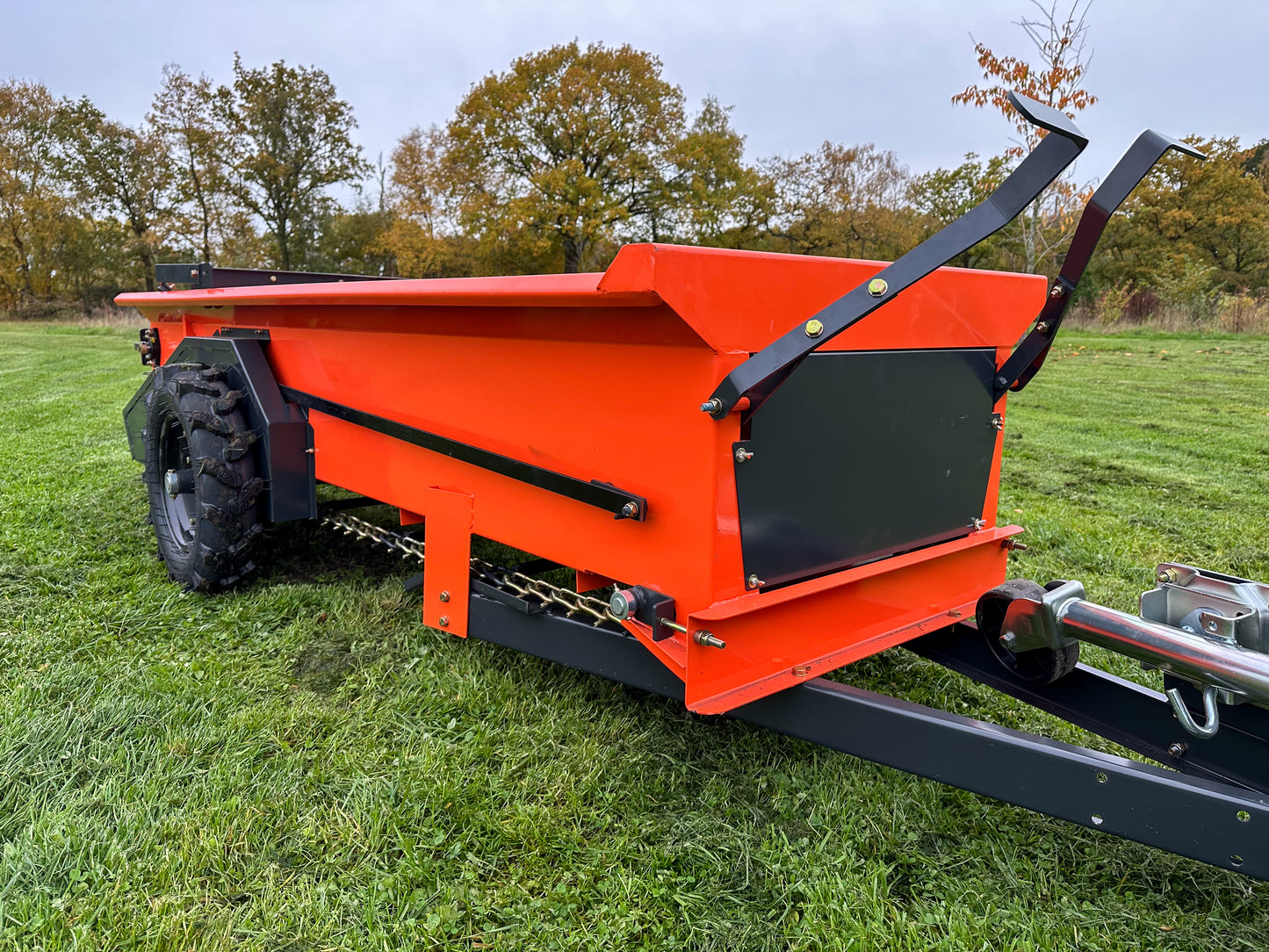 FarmMaster muck spreader on grass with trees in the background