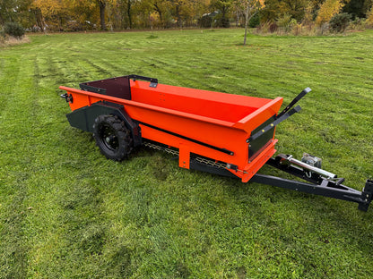 FarmMaster muck spreader on a grassy field with trees in the background