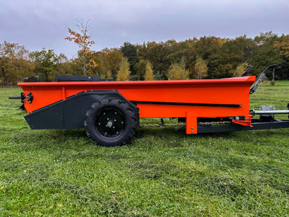FarmMaster muck spreader on grass with trees in the background