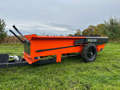 FarmMaster muck spreader on a grassy field with trees in the background