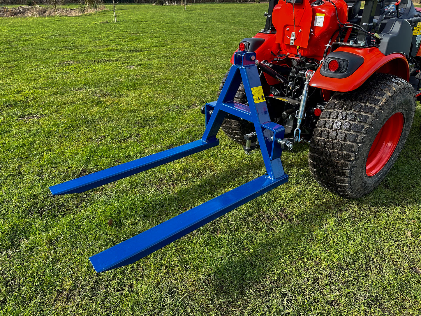 Kioti tractor with a FarmMaster tractor pallet forks
