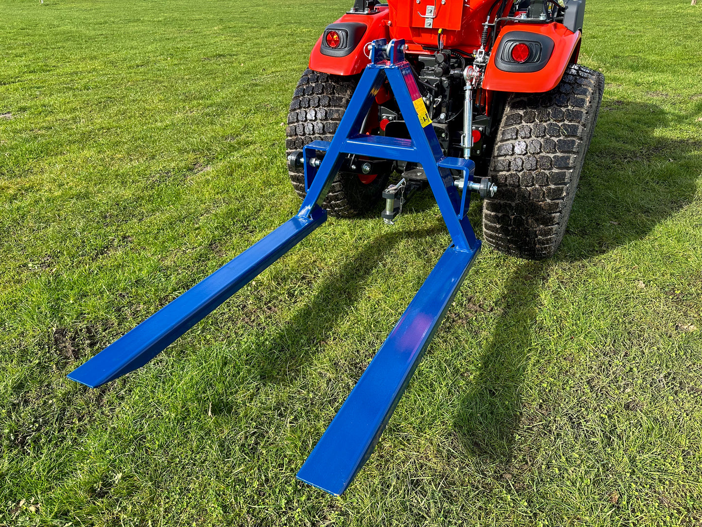 Kioti tractor with a FarmMaster tractor pallet forks