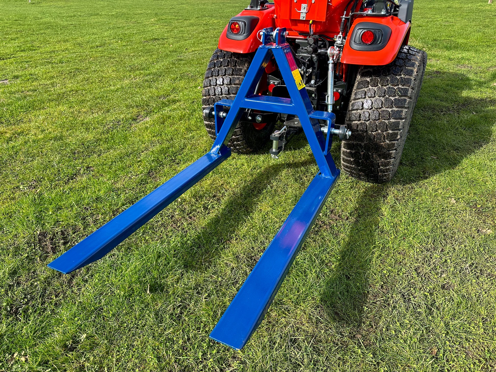 Kioti tractor with a FarmMaster tractor pallet forks