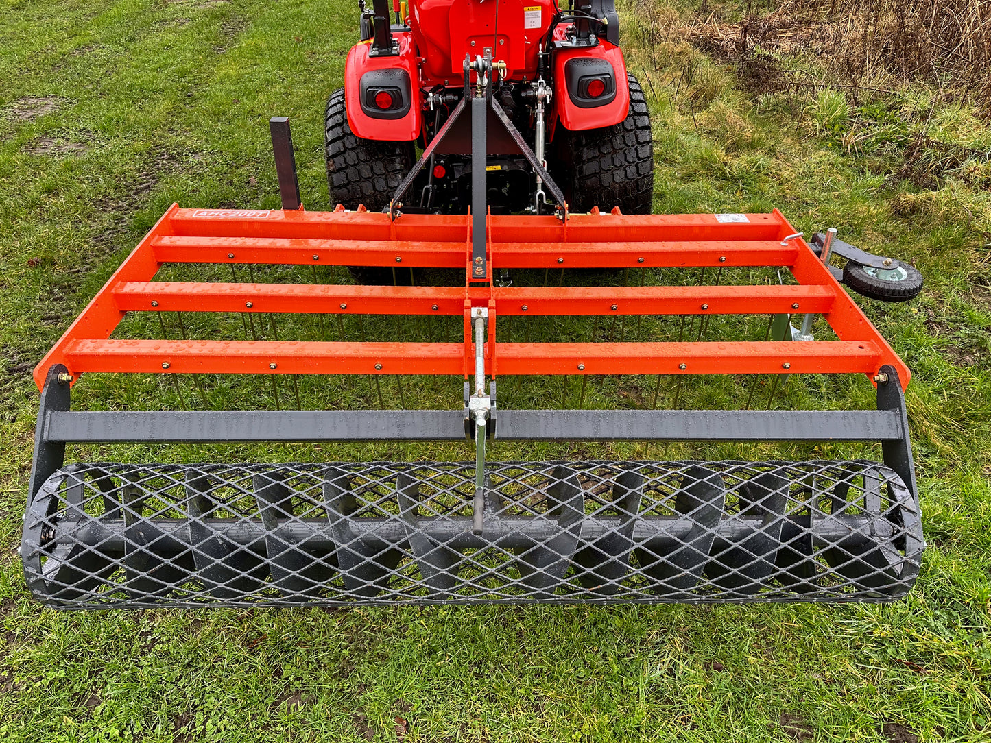 FarmMaster tractor arena conditioner attached to a Kioti tractor on grass