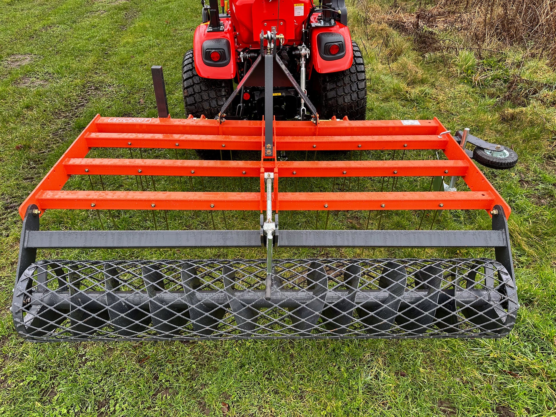 FarmMaster tractor arena conditioner attached to a Kioti tractor on grass