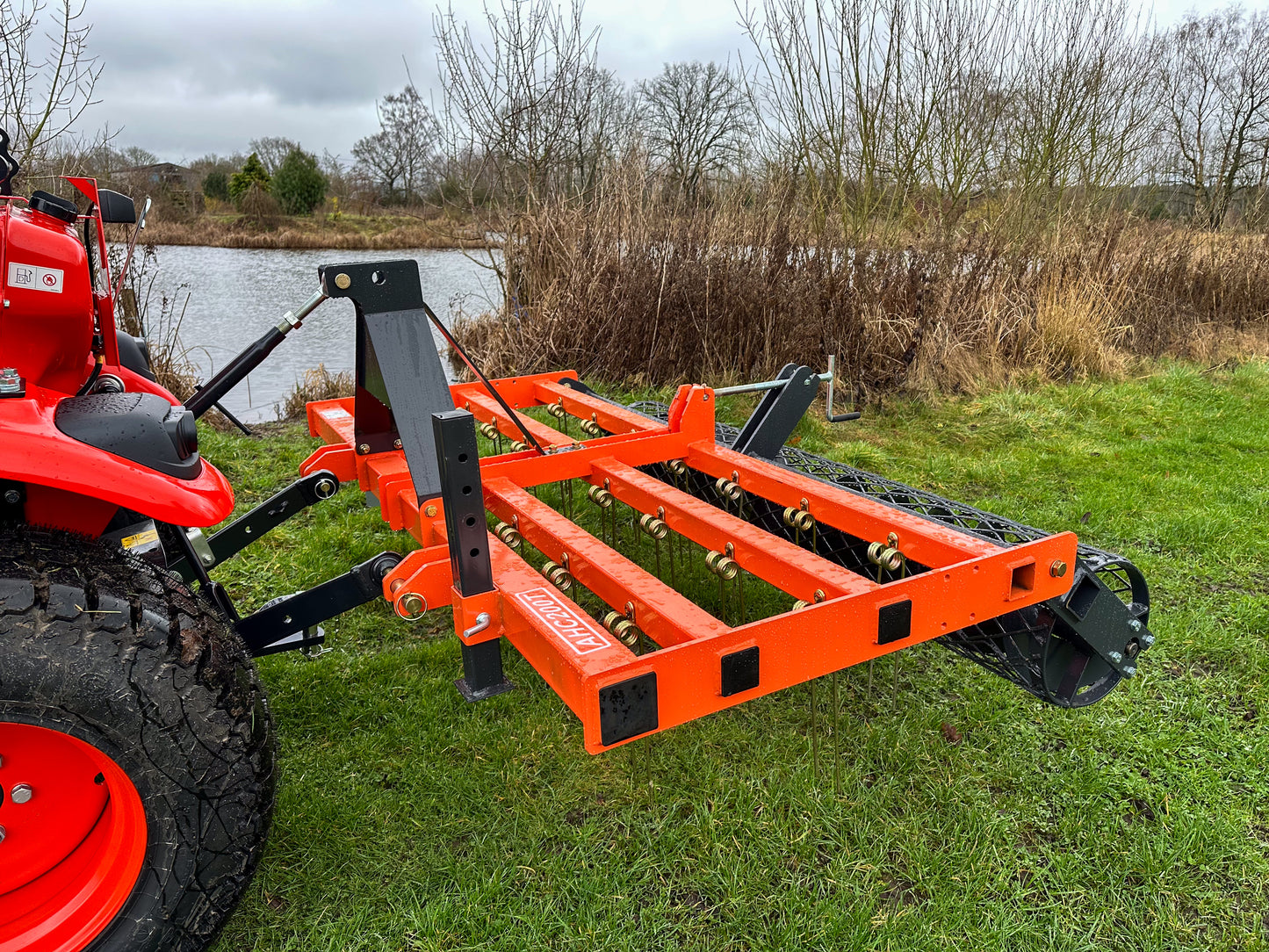 Kioti tractor with an attached FarmMaster tractor arena conditioner