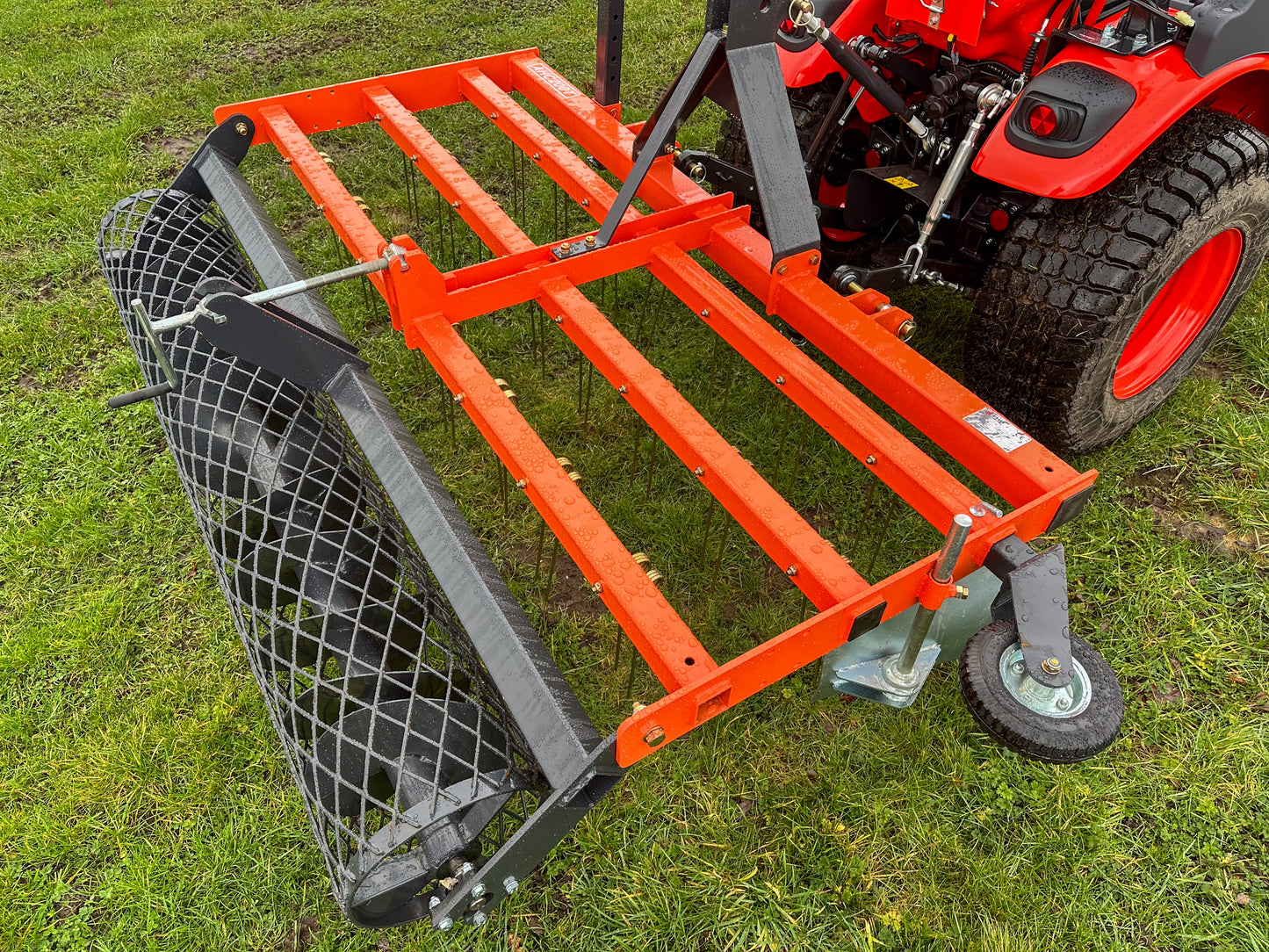 FarmMaster tractor arena conditioner attached to a tractor on grass