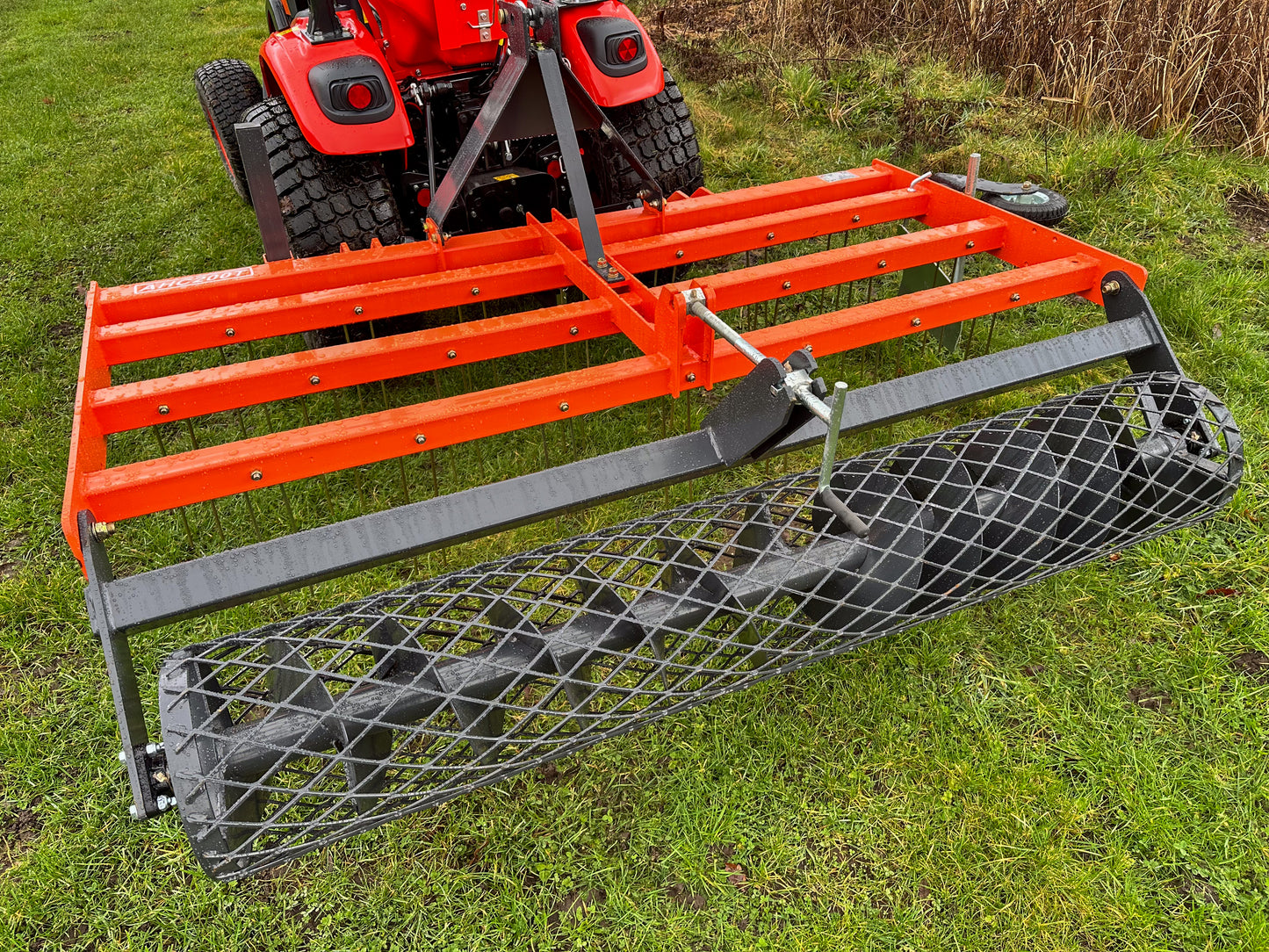 Kioti tractor with a FarmMaster tractor arena conditioner on a grassy field