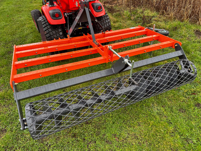 Kioti tractor with a FarmMaster tractor arena conditioner on a grassy field