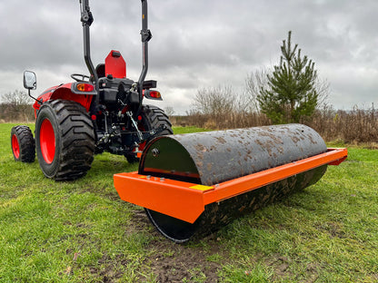 Tractor with a FarmMaster tractor land roller on a grassy field