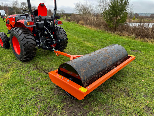 Tractor with a FarmMaster tractor land roller on a grassy field