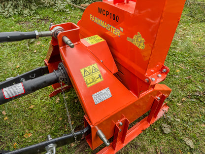 FarmMaster tractor wood chipper on a grassy background