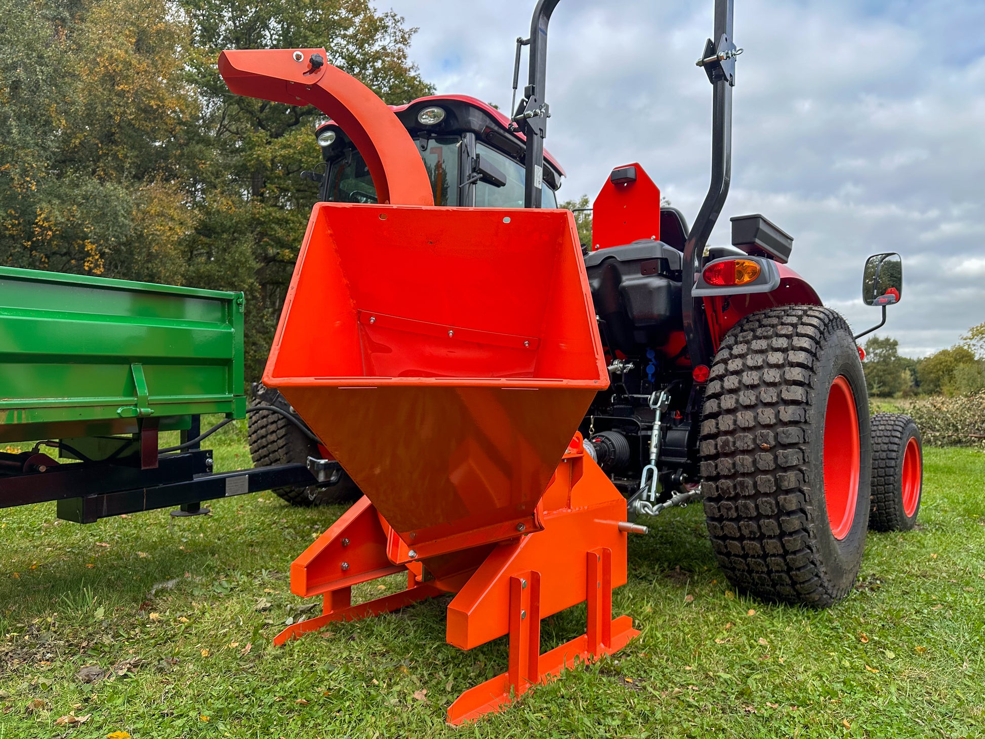 FarmMaster tractor wood chipper on a grassy field.