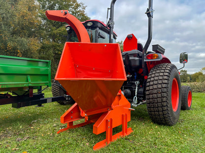 FarmMaster tractor wood chipper on a grassy field.