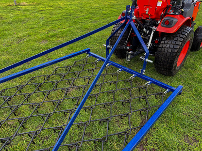 FarmMaster Framed Chain Harrow attached to a Kioti tractor on grass