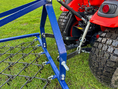 Kioti tractor with a FarmMaster Framed Chain Harrow on a grassy field