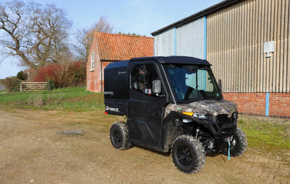 CFMOTO UFORCE 600 Highland UTV parked on a dirt road with a building and trees in the background